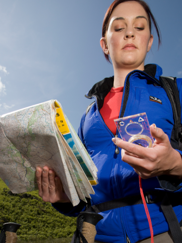  A packed backpack and a worn map spread out on a bed, with train tickets and a worn compass scattered nearby.