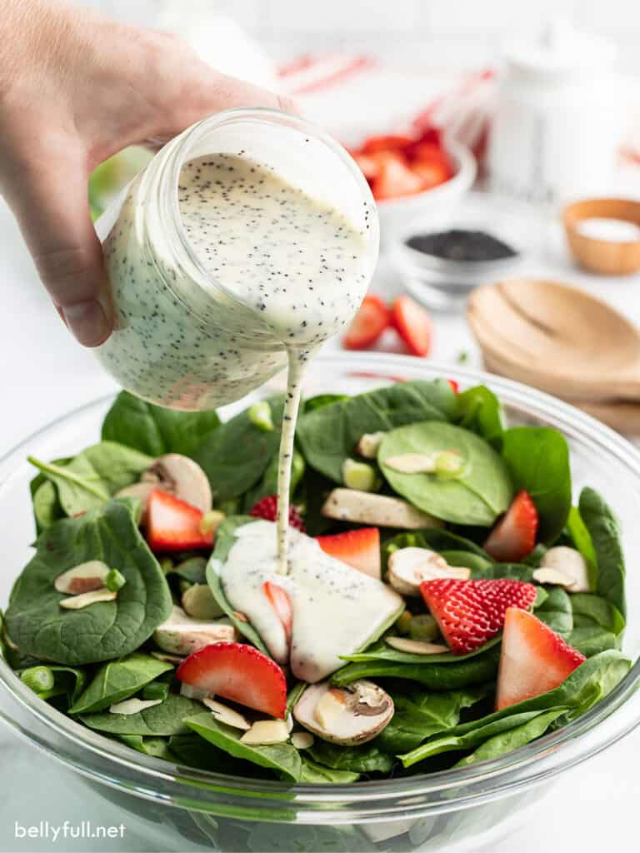 A small bowl with a whisk and the dressing ingredients (mayonnaise, sugar, vinegar, poppyseeds) being whisked together.