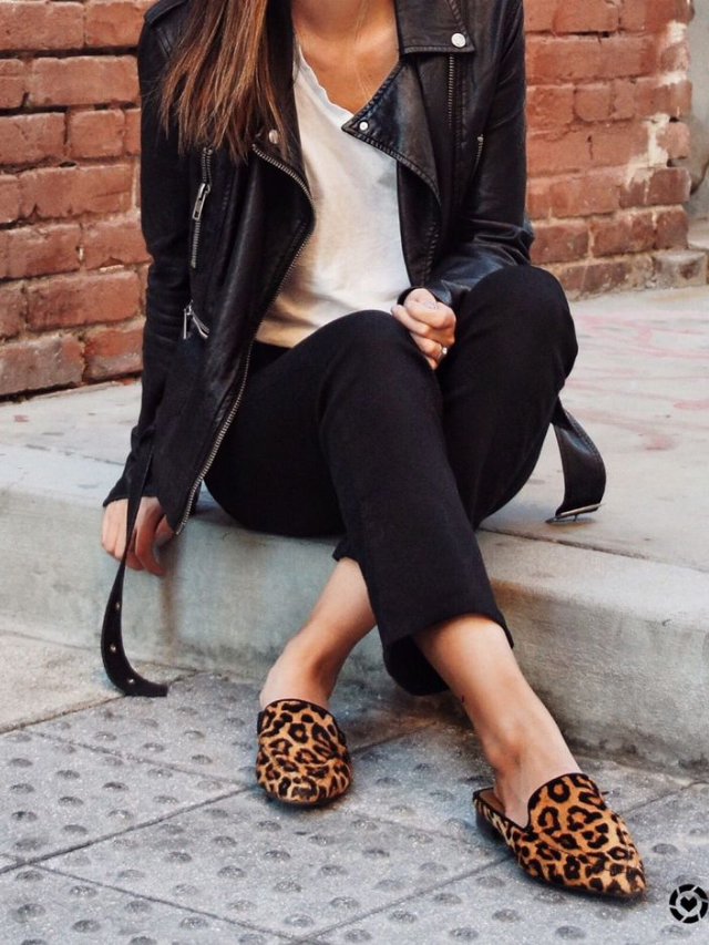 A woman relaxing on a park bench, wearing comfortable and stylish 