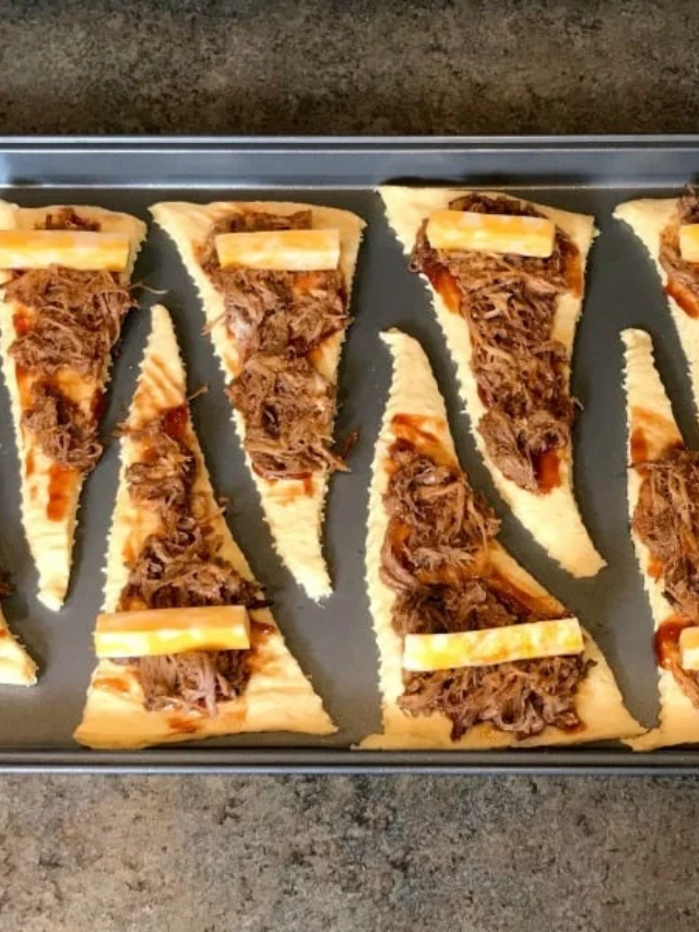 Spread a thin layer of BBQ sauce over the dough, leaving a 1-inch border around the edge.
Top with a generous amount of pulled pork.
Sprinkle the shredded cheddar cheese evenly over the pulled pork.
Scatter the thinly sliced red onion on top of the cheese.
