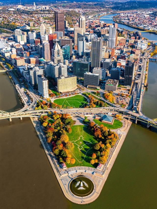 A warm and welcoming photo of Pittsburgh's skyline at dusk, with the three rivers sparkling in the foreground.
