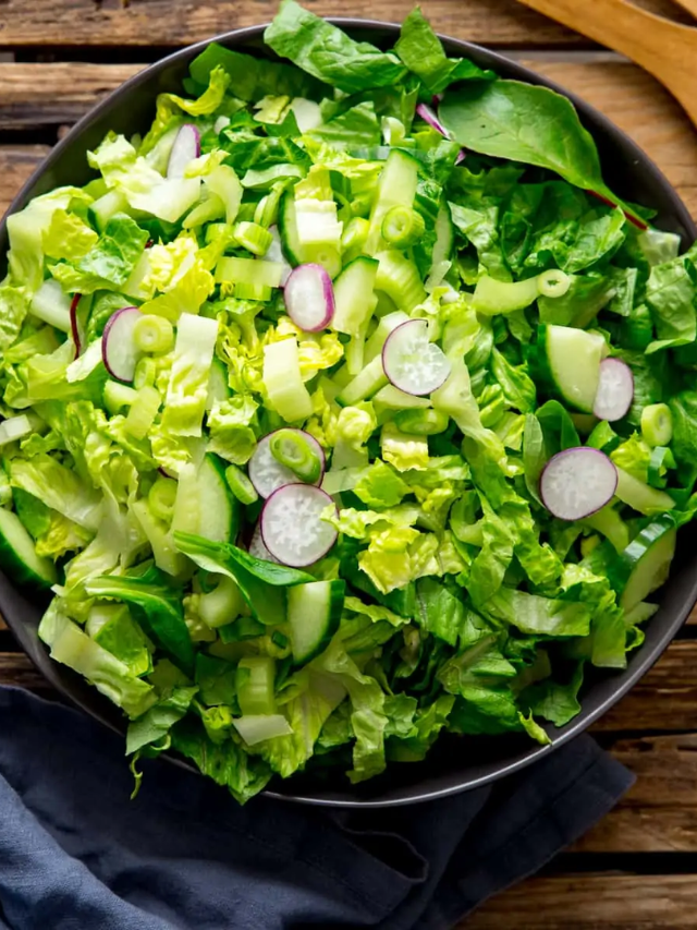 A colorful salad with grilled chicken, mixed greens, cherry tomatoes, cucumbers, and a creamy avocado dressing.
