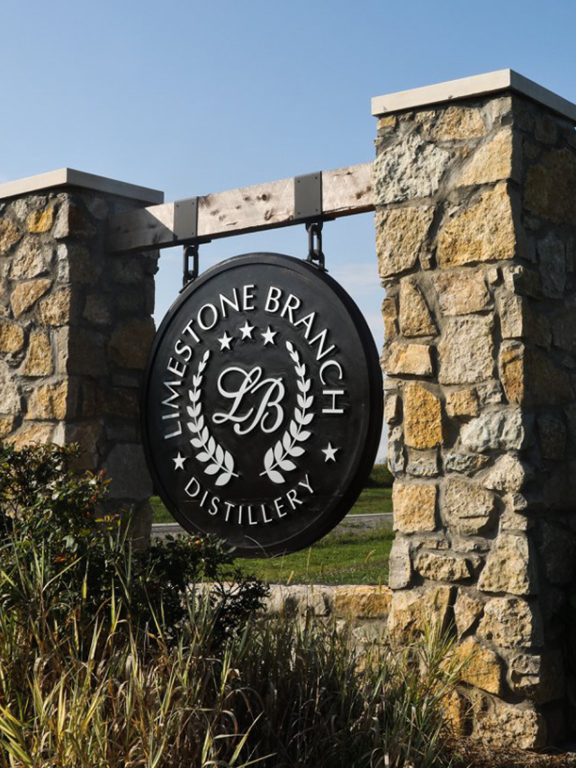 A tour guide leading visitors through a historic bourbon distillery.
