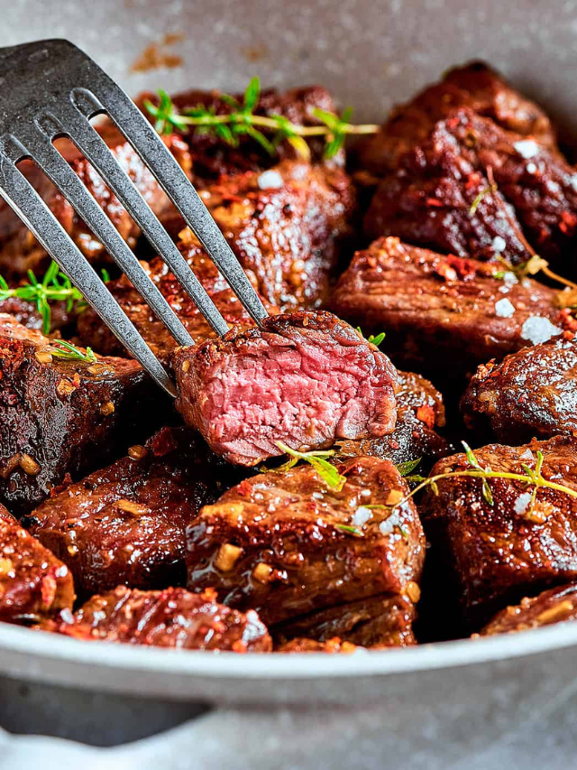  A small dish filled with a rich, brown steak sauce.
