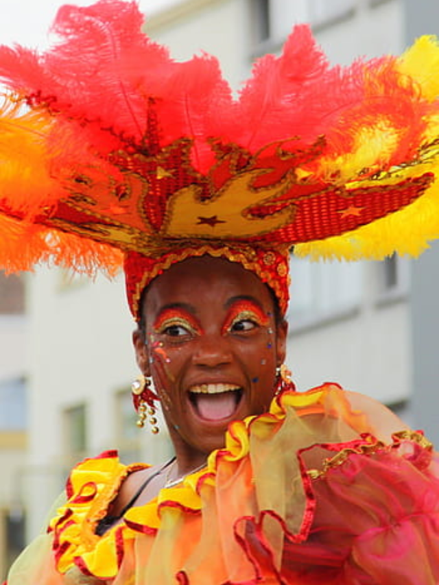 A photo of a vibrant Mardi Gras parade, filled with colorful floats, costumes, and revelers.
