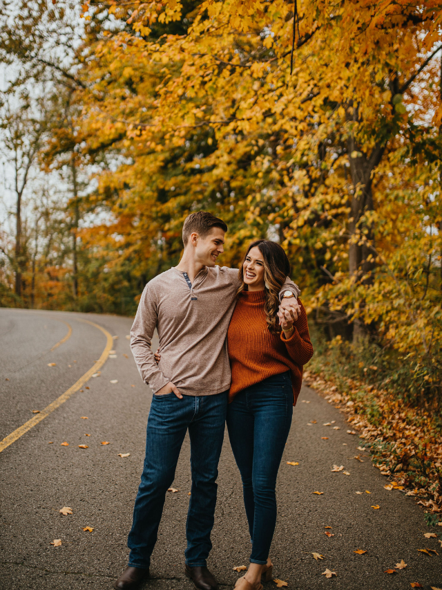 A couple walking hand-in-hand through a lush garden path at the Louisville Waterfront Botanical Gardens.
