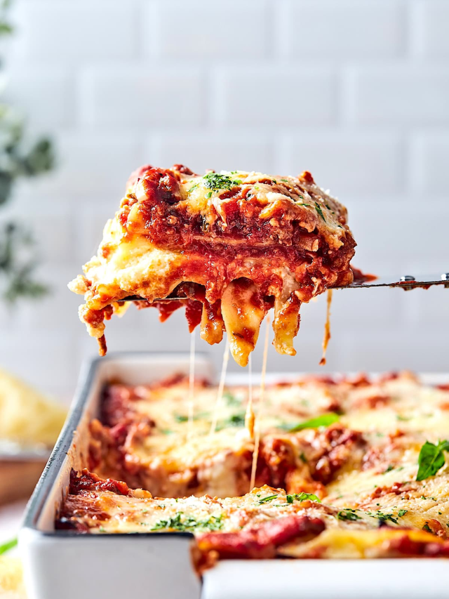 A plate of creamy lasagna with melted cheese bubbling on top.
