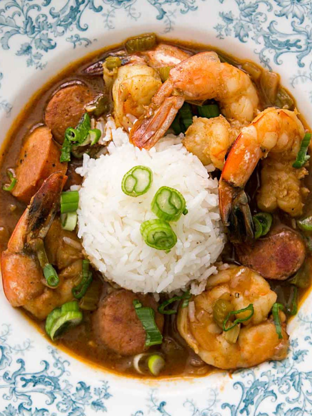 A photo of a plate of steaming Mobile gumbo, featuring shrimp, sausage, okra, and rice.
