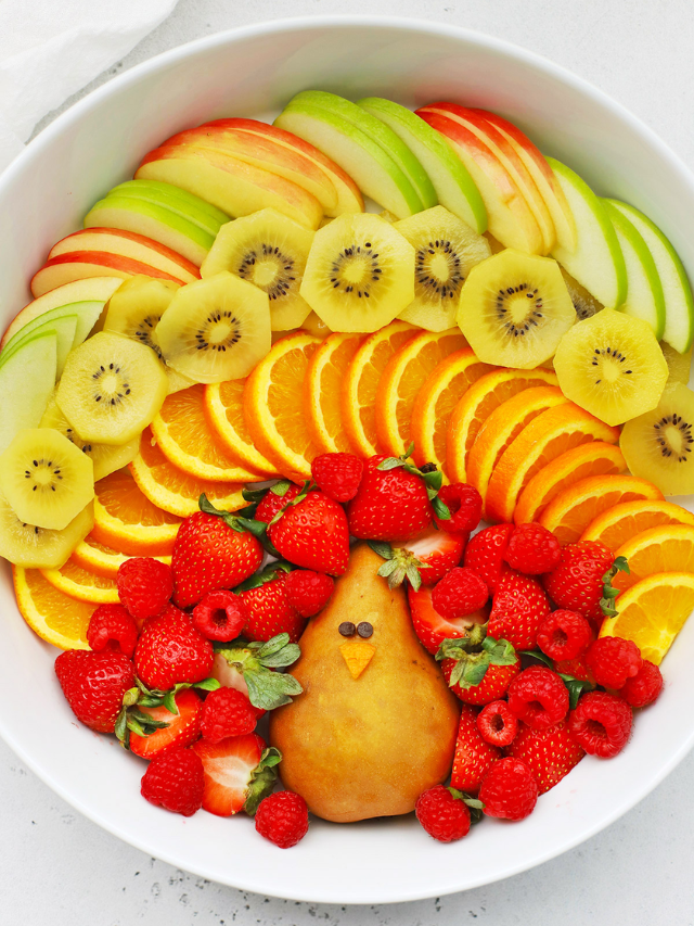 A fun fruit and veggie platter with cut-up shapes like stars and hearts.
