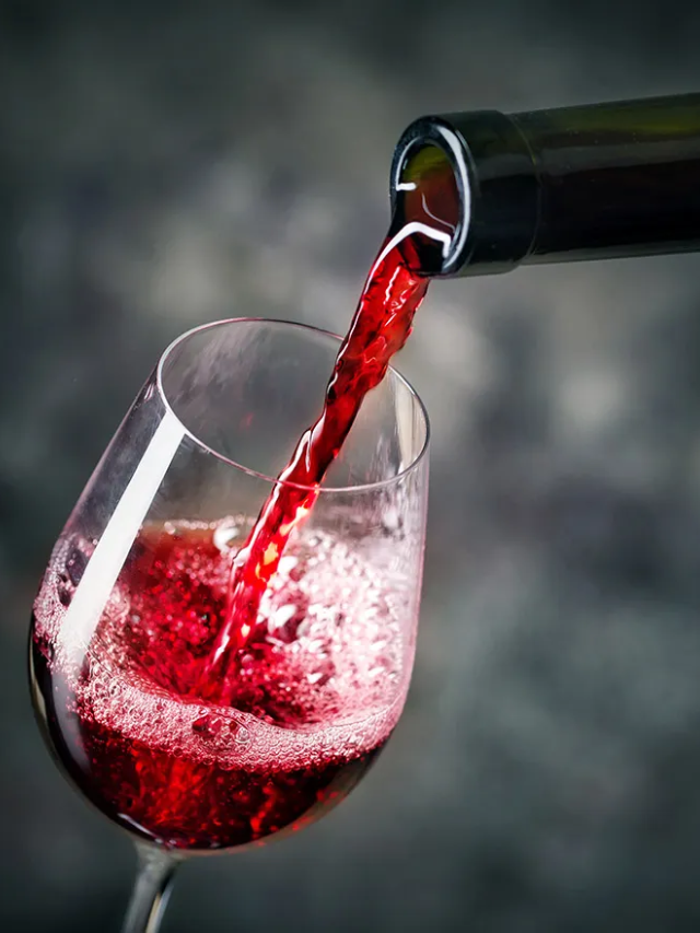 A red wine being poured into a glass.
