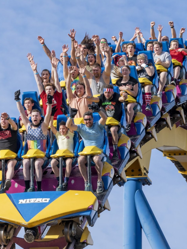 Families laughing and playing at Six Flags Great Adventure amusement park.
