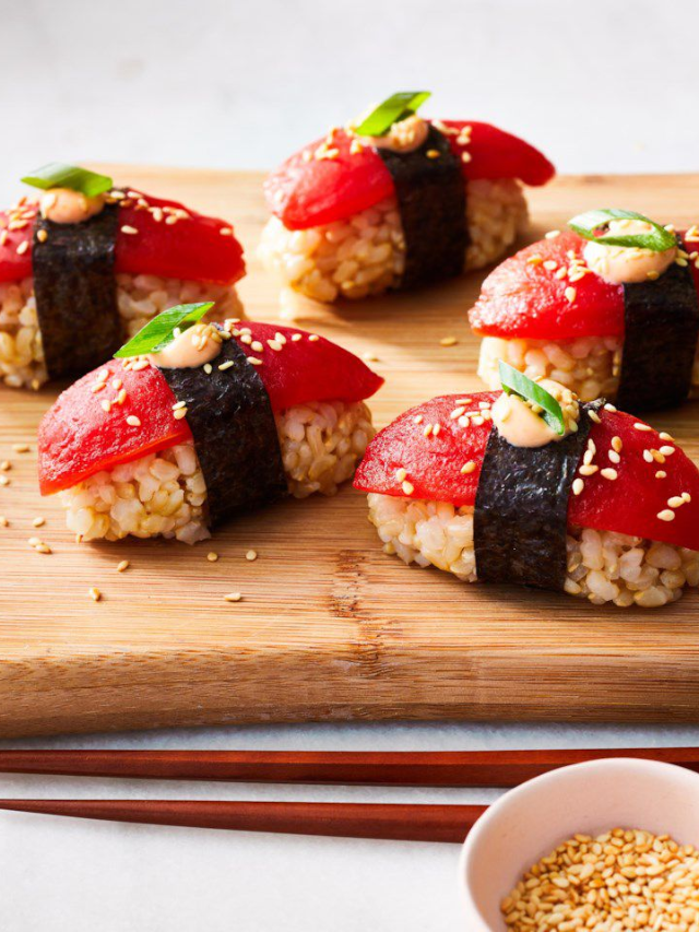 A colorful vegetarian sushi platter with various vegetable fillings.
