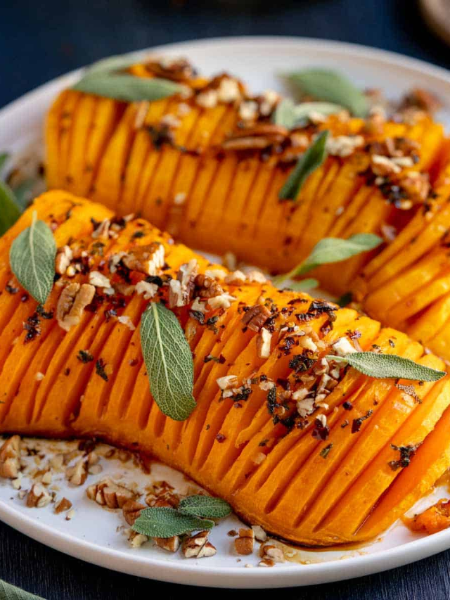 A casserole dish filled with a creamy butternut squash mixture topped with toasted bread crumbs.
