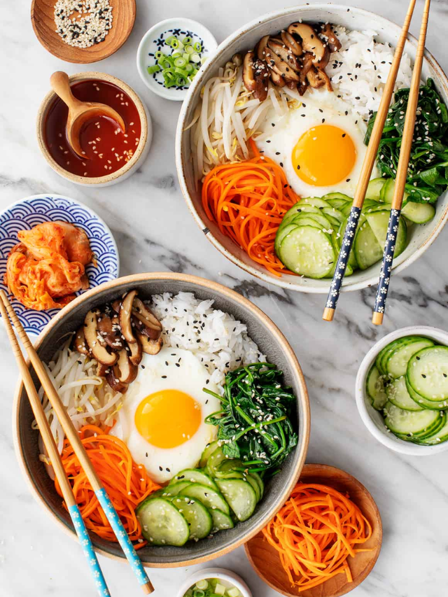 A close-up of a Korean-style ground beef bowl with kimchi and a fried egg.

