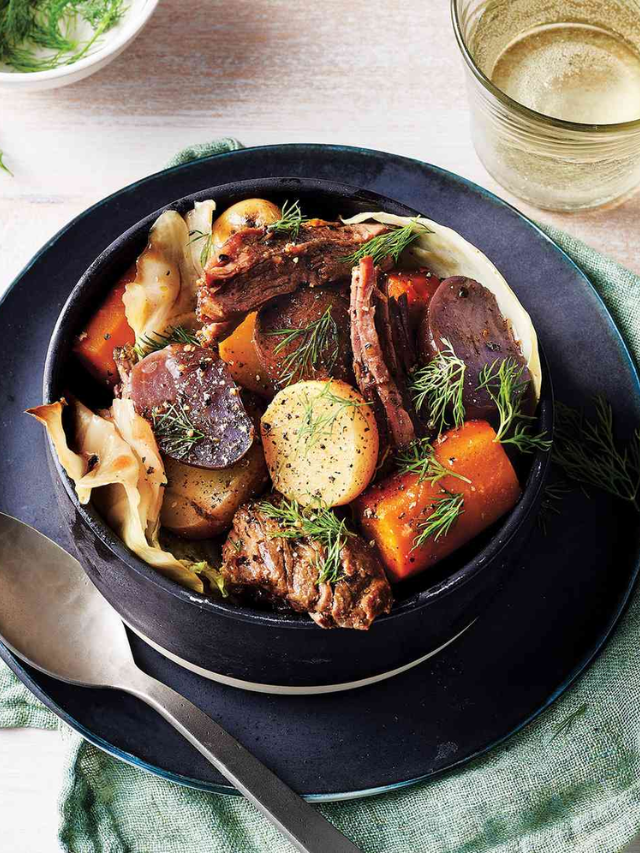  A slow cooker filled with a rich beef stew with vegetables and potatoes.
