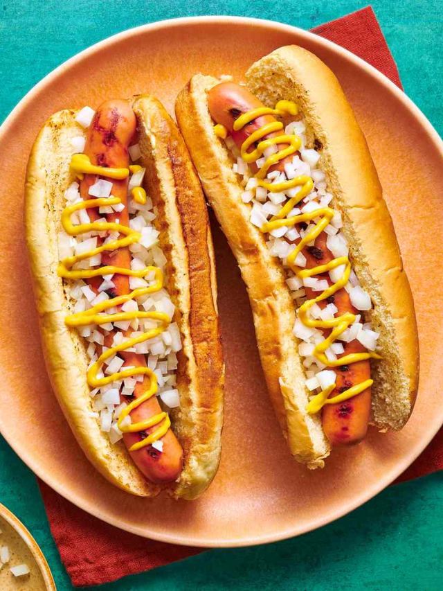 A close-up photo of a delicious plate with Sonoran Dog (bacon-wrapped hot dog) and prickly pear fries.
