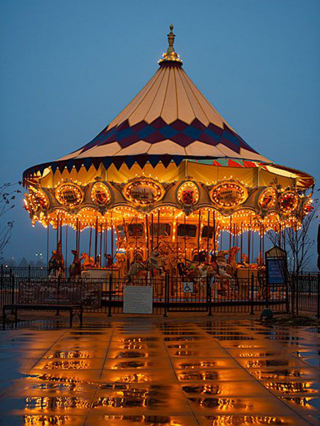  Pullen Park with a carousel and families enjoying the outdoors.
