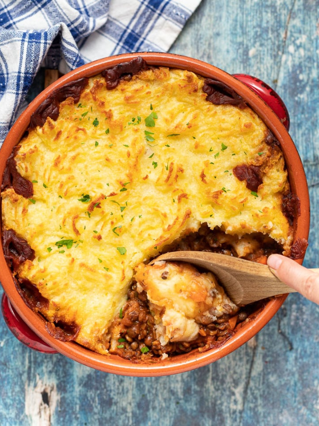 A golden-brown lentil shepherd's pie in a baking dish.
