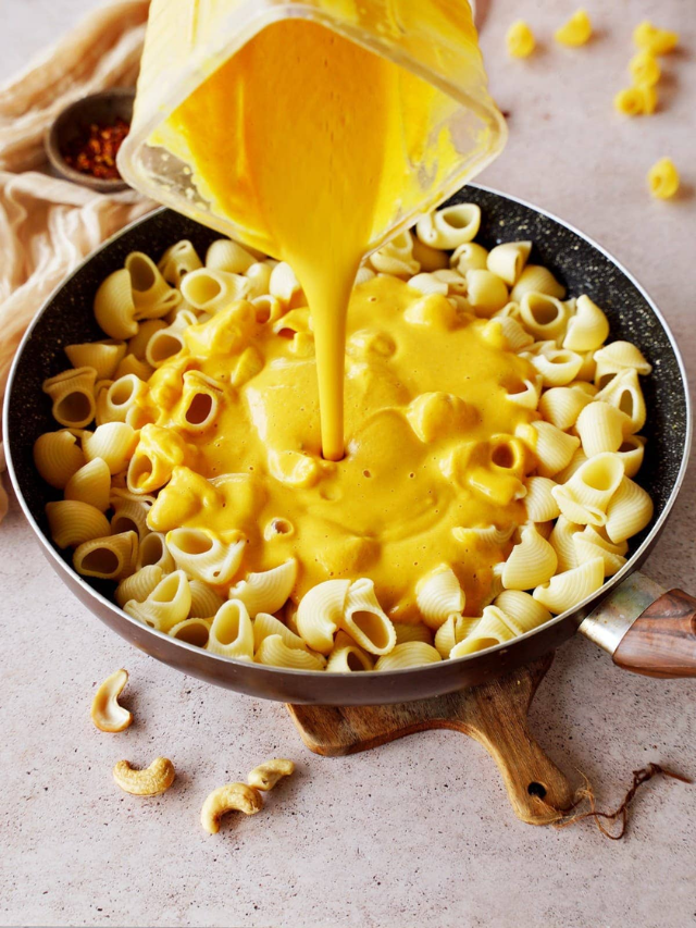 A steaming bowl of creamy mac and cheese with a sprinkle of breadcrumbs.
