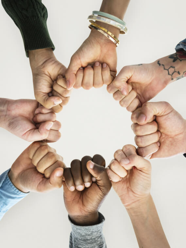  A group of people holding hands around the table, sharing their gratitude with each other.
