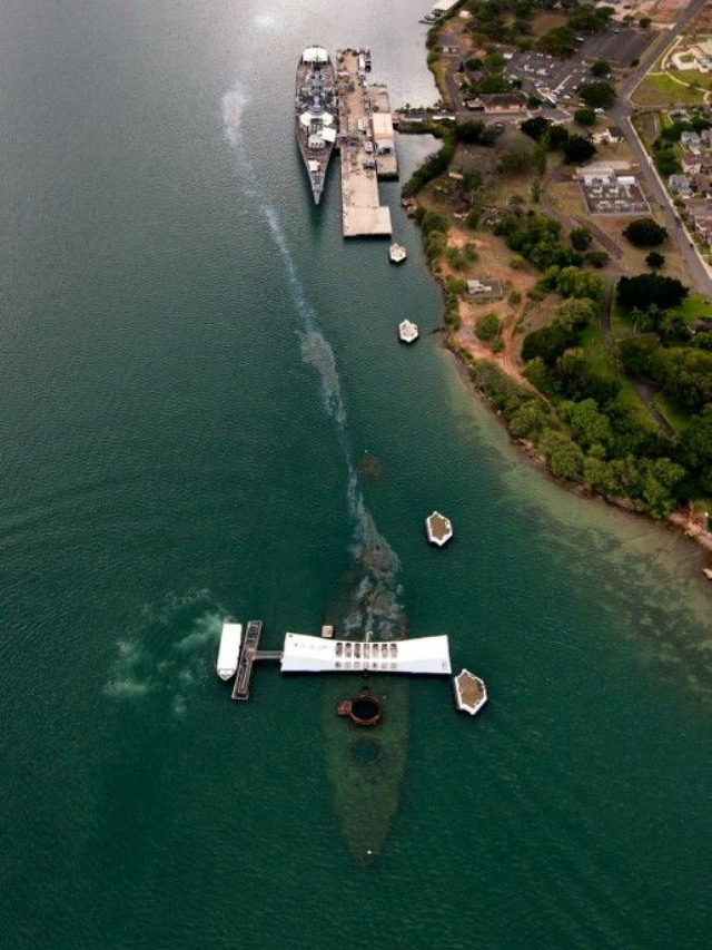 A panoramic view of Pearl Harbor with the USS Arizona Memorial in the foreground.
