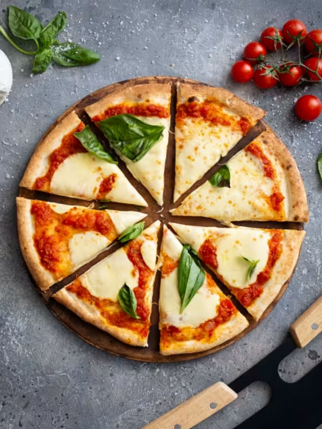 A homemade pizza with a variety of toppings on a rustic wooden table.

