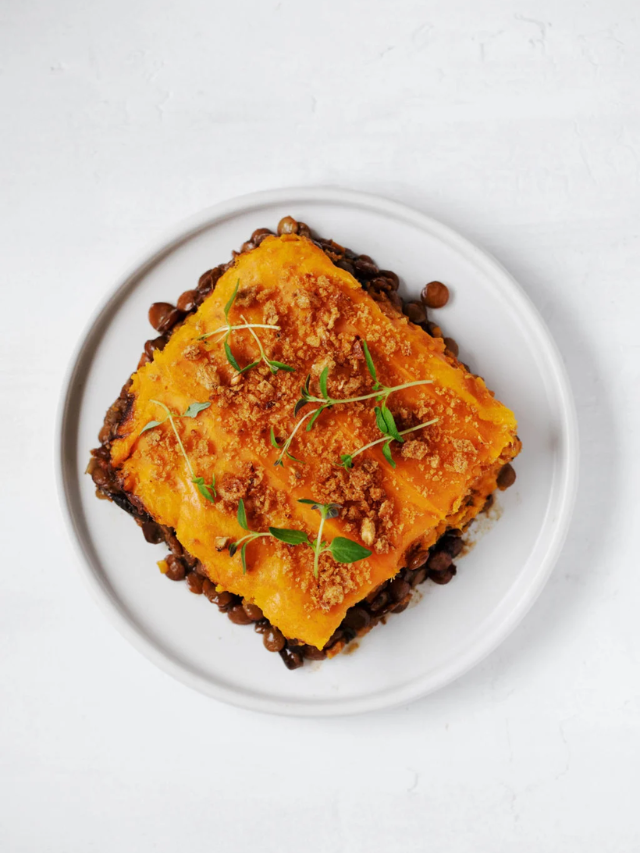 A plate of lentil shepherd's pie topped with mashed potatoes.