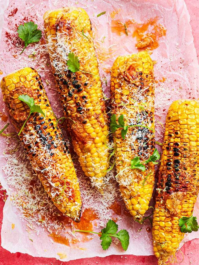 Grilled asparagus, corn on the cob, and sliced bell peppers
