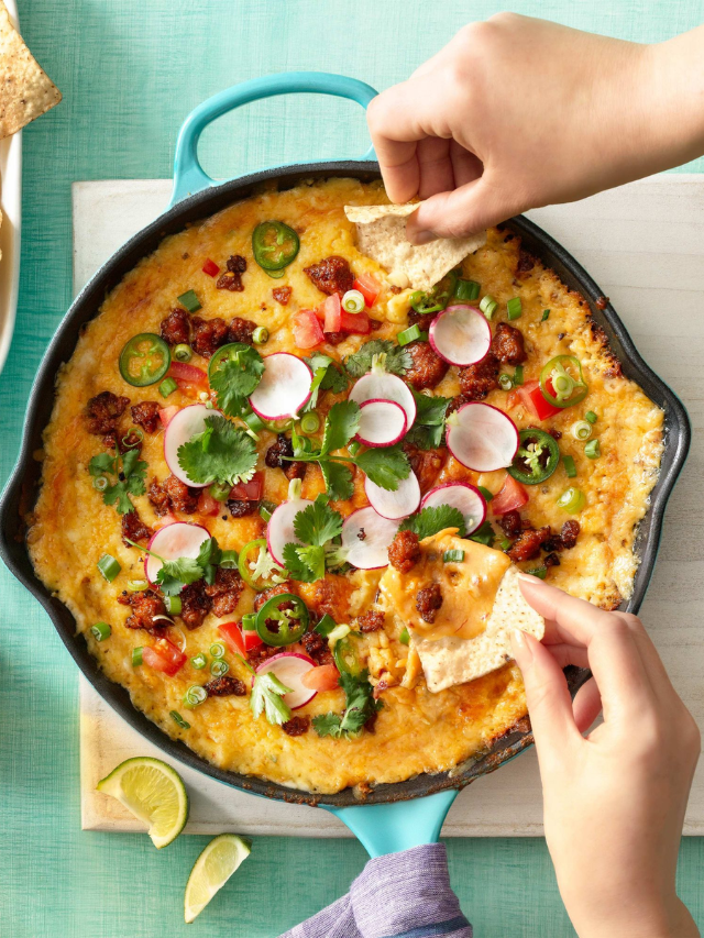 A cast-iron pot filled with a cheesy ground beef and noodle casserole.
