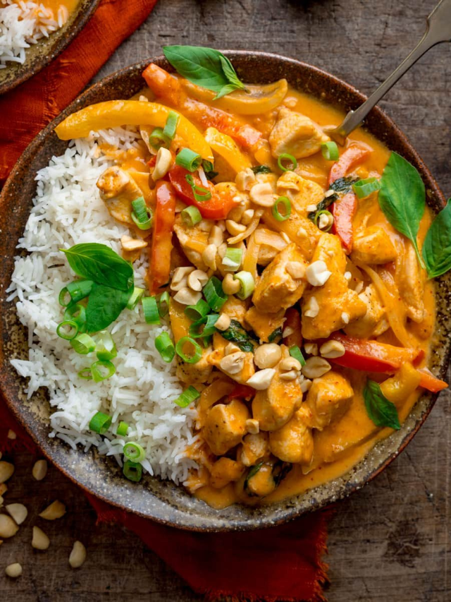 A red curry with chicken and vegetables served over rice.
