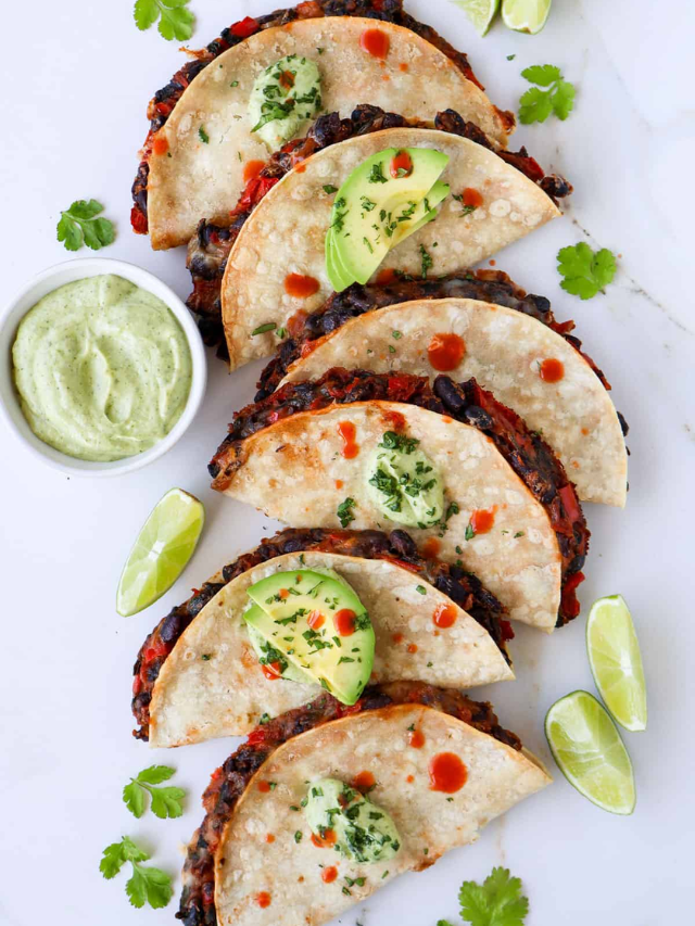 A healthy taco filled with grilled chicken, black beans, corn salsa, and avocado slices on a whole-wheat tortilla.
