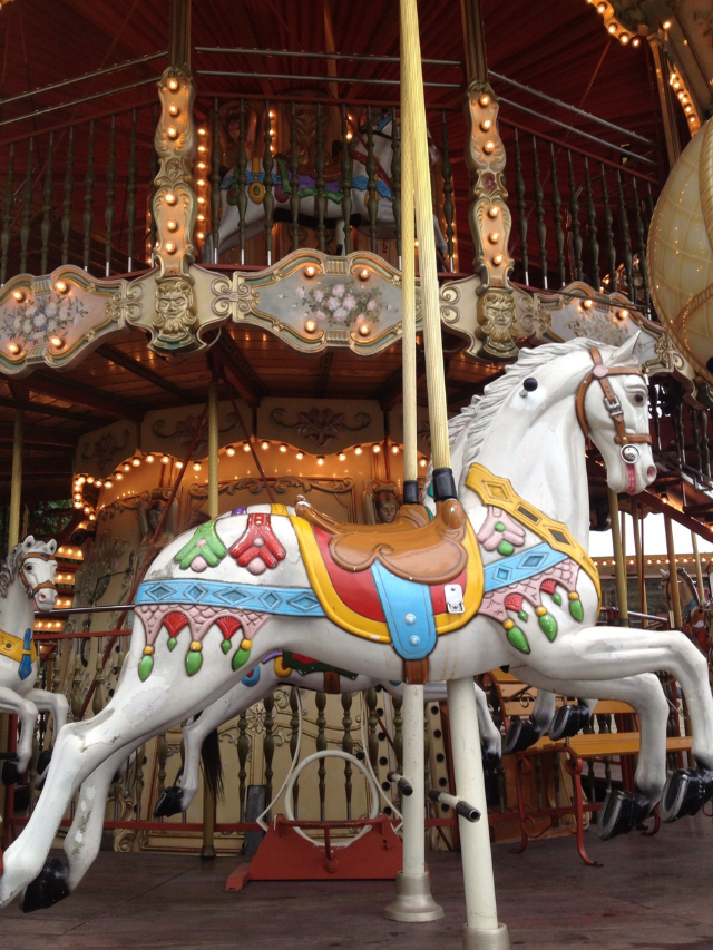 The historic Santa Monica Pier carousel, hand-carved in 1922, with its colorful horses and calliope music.
