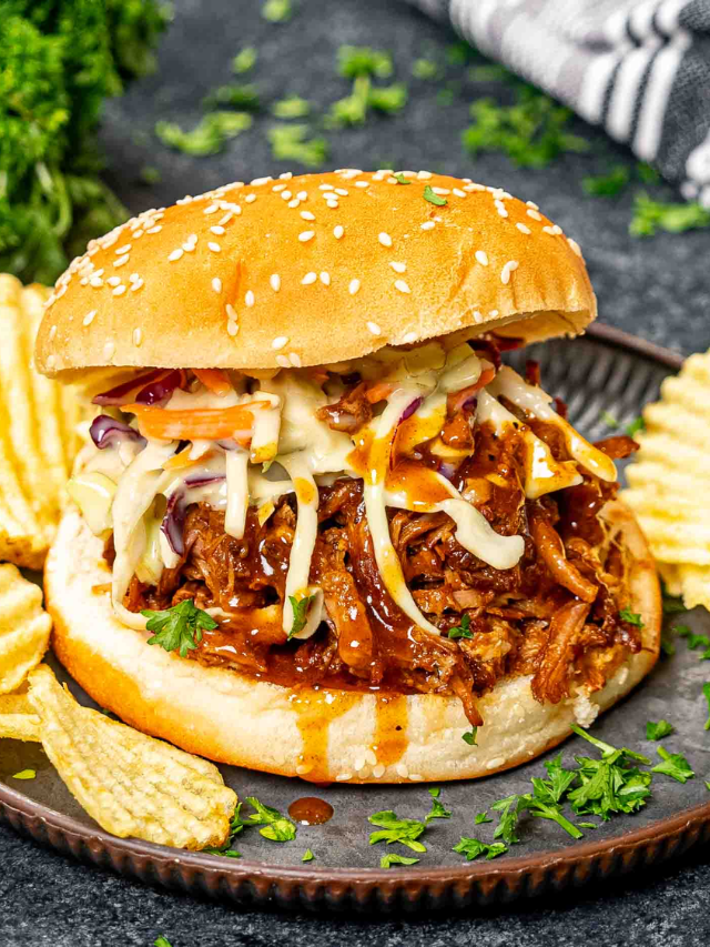  Close-up shot of a plate of Carolina barbecue with pulled pork and coleslaw.
