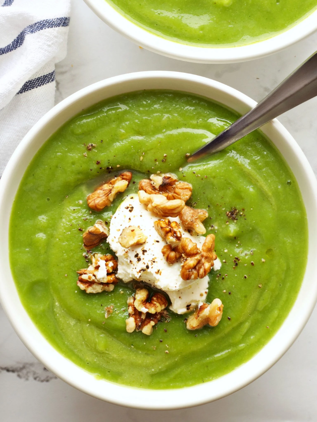  A steaming bowl of chunky vegetable soup with a side of crusty bread.
