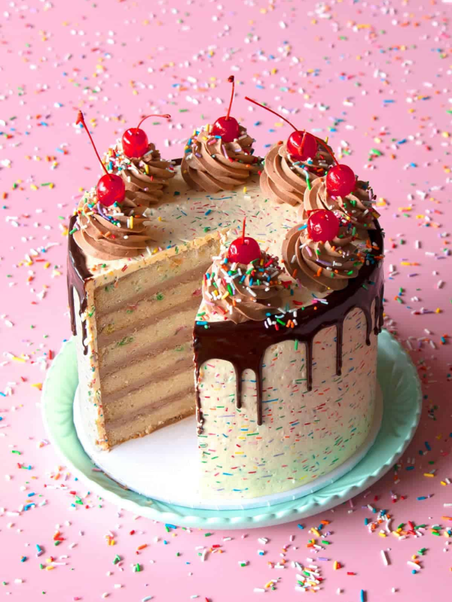 A slice of rich chocolate cake with a scoop of vanilla ice cream.
