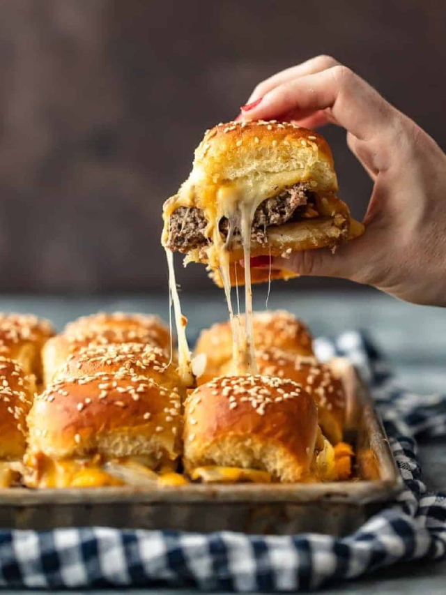 A platter of mini cheeseburgers with ketchup and mustard dipping cups.
