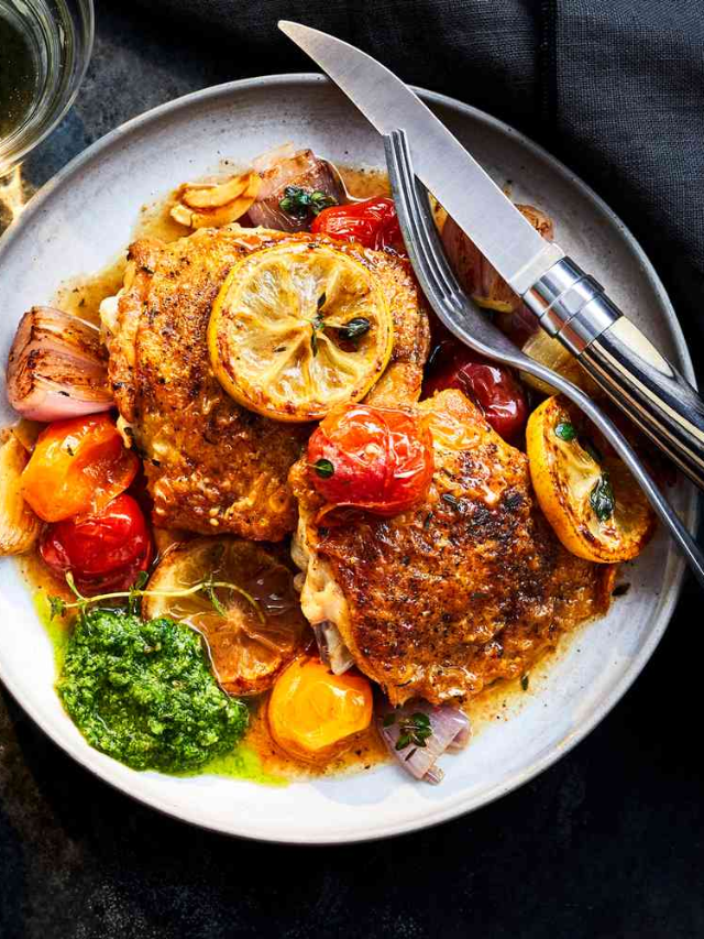 A plate of pan-seared chicken with roasted fennel and citrus slices.
