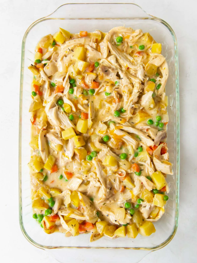 A bubbling casserole dish of creamy chicken and rice with a golden brown crust.
