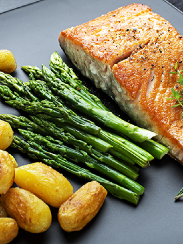 A sheet pan with roasted salmon and asparagus
