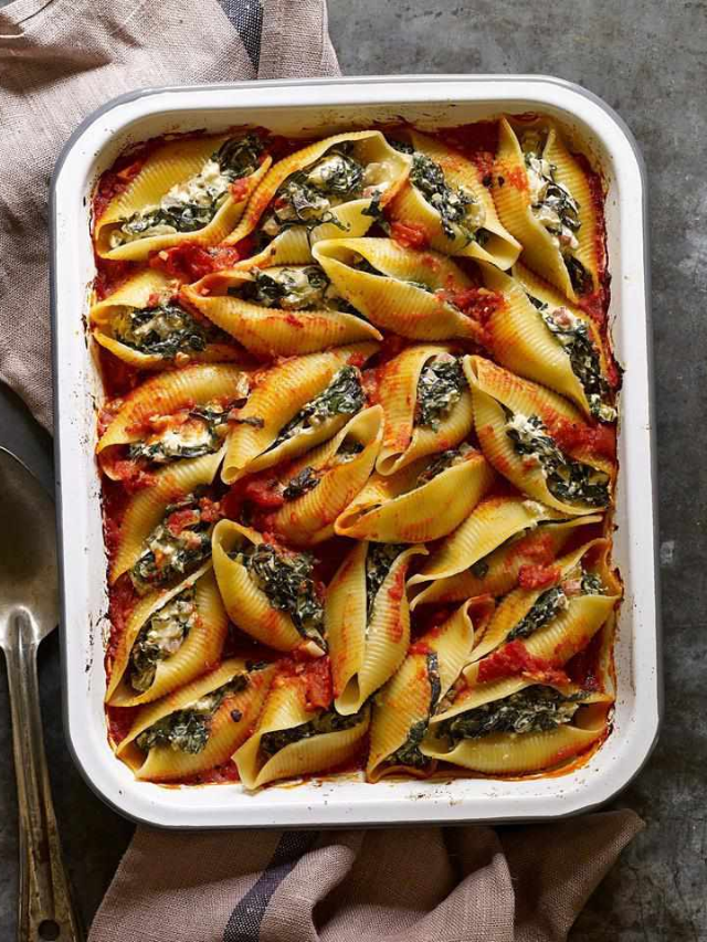  A baking dish filled with a cheesy kale and sausage pasta bake.
