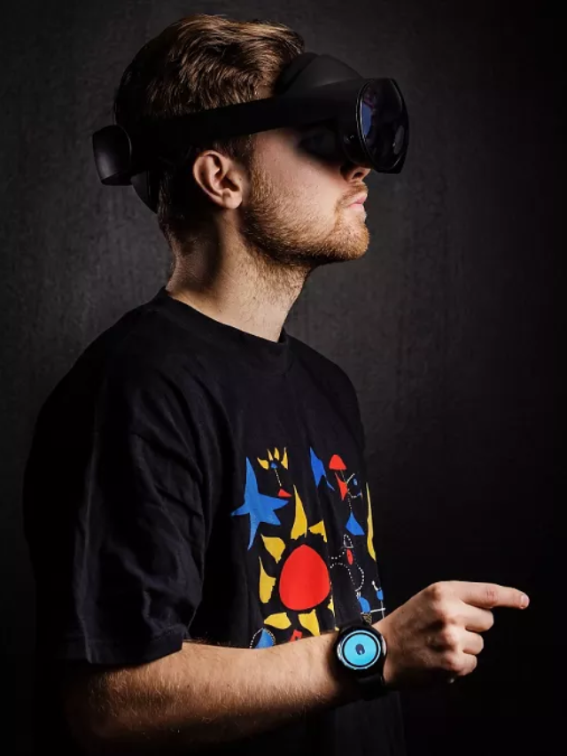  A person wearing AR glasses and a wristband, using gestures on the wristband to control the AR interface.

