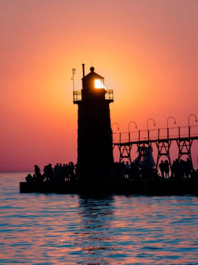  Sunset over the Mackinac Bridge, casting a golden glow on the sky and water.
